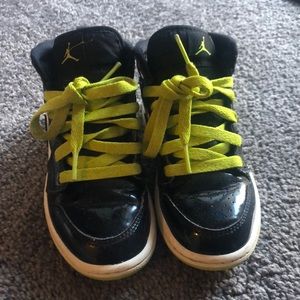 Boys Jordan’s size 11.5 black patent and white with lime green sole and laces